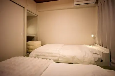 a bedroom with two beds and a closet at Tokyo Retreat -SUMIDA- in Tokyo