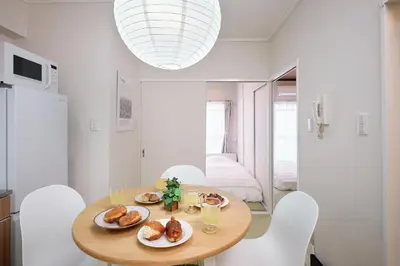 a dining room with a table with plates of food at Tokyo Retreat -SUMIDA- in Tokyo