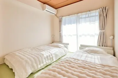 a white bedroom with a bed and a window at Tokyo Retreat -SUMIDA- in Tokyo