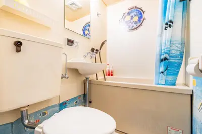 a bathroom with a toilet and a sink at \u65b0\u5bbf\u5f92\u6b69\u570f\u306e\u30db\u30c6\u30eb\u897f\u65b0\u5bbf\u4e94\u4e01\u76ee\u99c52\u5206 in Tokyo
