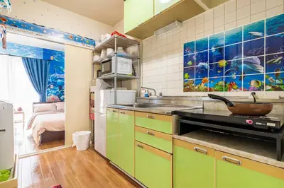 a kitchen with green cabinets and a sink at \u65b0\u5bbf\u5f92\u6b69\u570f\u306e\u30db\u30c6\u30eb\u897f\u65b0\u5bbf\u4e94\u4e01\u76ee\u99c52\u5206 in Tokyo