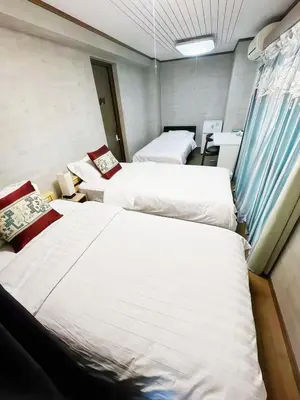 a room with three beds in it with at \u70df\u96e8\u8f69301\u65b0 in Tokyo