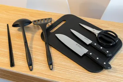 a black cutting board with utensils on a table at \u548c\u6c23\u4f1a\u3005\u6e0b\u8c37\u672c\u753a Wakiaiai Shibuyahontyo in Tokyo
