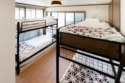 a bedroom with two bunk beds in a room at \u548c\u6c23\u4f1a\u3005\u6e0b\u8c37\u672c\u753a Wakiaiai Shibuyahontyo in Tokyo
