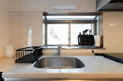 a kitchen with a sink and a window at \u548c\u6c23\u4f1a\u3005\u6e0b\u8c37\u672c\u753a Wakiaiai Shibuyahontyo in Tokyo