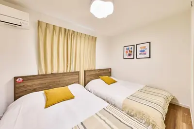 two beds sitting next to each other in a bedroom at Villa Sumida Five in Tokyo