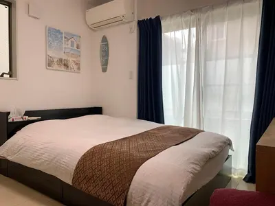 a bedroom with a bed and a window at itabashi-ku5 minutes to station 103 in Tokyo