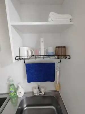 a kitchen sink with a shelf above the sink at \u6771\u4eac\u5929\u7a7a\u4e4b\u5bb6\u65c5\u9986103\u72ec\u7acb\u516c\u5bd3 \u72ec\u7acb\u536b\u6d74 in Tokyo