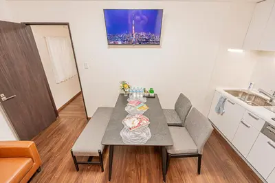 a small kitchen with a table and chairs in a room at \u83ef\u590f\u6c11\u5bbf in Tokyo