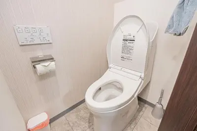 a bathroom with a toilet with the lid up at \u83ef\u590f\u6c11\u5bbf in Tokyo
