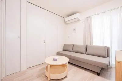 a living room with a couch and a table at 67 Apartment Ueno in Tokyo