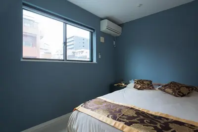 a bedroom with a bed with a large window at MEET IN SKYtree in Tokyo