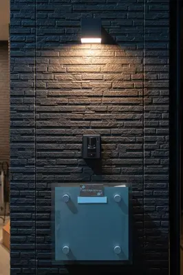 a wall with a urinal in front of a brick wall at MEET IN SKYtree in Tokyo