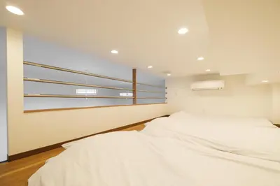 a bedroom with two beds and a window at Hearty Stay Ikebukuro in Tokyo