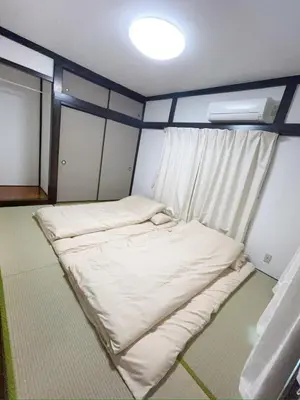 a small room with a bed and a window at \u4e1c\u4eac\u90fd\u5df4\u58eb\u76f4\u8fbe\u8fea\u65af\u5c3c\u4e50\u56ed Himawari \u53ef\u4f4f10\u4eba in Tokyo