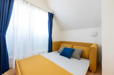 a yellow couch in a room with a window at \u7d50\u5eb5\u82b1\u9ce5 in Tokyo