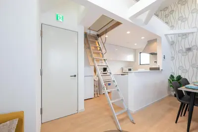 a ladder leading up to a kitchen in a loft at \u7d50\u5eb5\u82b1\u9ce5 in Tokyo