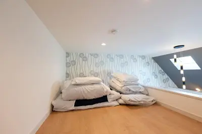 a room with a pile of blankets on the floor at \u7d50\u5eb5\u82b1\u9ce5 in Tokyo
