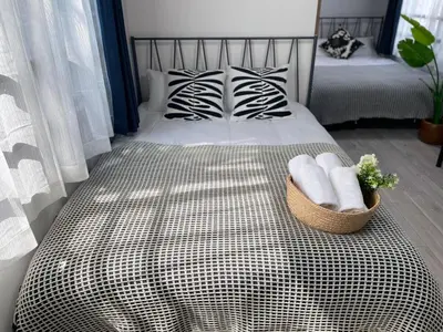 a bedroom with a bed with a basket of towels at Comma House Otsuka 102 in Tokyo