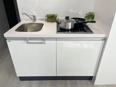 a kitchen counter with a sink and a stove at Comma House Otsuka 102 in Tokyo