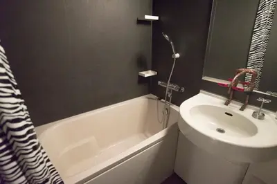 a bathroom with a white tub and a sink at AMs house 5 min to Ikebukuro 13 min to Shinjuku Station 19 min to Shibuya Station in Tokyo