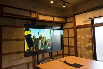 a flat screen tv on a wall in a room at AMs house 5 min to Ikebukuro 13 min to Shinjuku Station 19 min to Shibuya Station in Tokyo