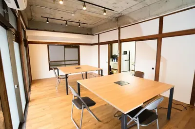 a meeting room with two tables and chairs at AMs house 5 min to Ikebukuro 13 min to Shinjuku Station 19 min to Shibuya Station in Tokyo