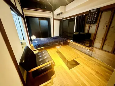 a living room with a couch and a television at AMs house 5 min to Ikebukuro 13 min to Shinjuku Station 19 min to Shibuya Station in Tokyo