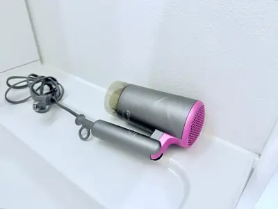 a blow dryer is attached to a wall at Terrace Tokyo Otsuka North in Tokyo