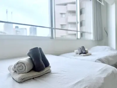 a hotel room with two towels on a bed at Terrace Tokyo Otsuka North in Tokyo