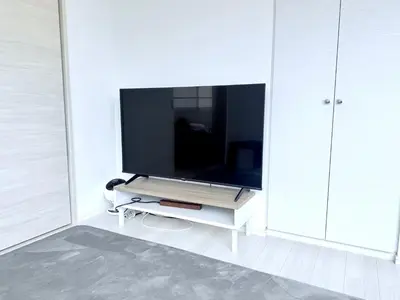 a flat screen tv sitting on a white cabinet at Terrace Tokyo Otsuka North in Tokyo