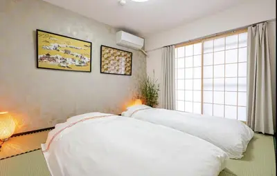 a bedroom with a white bed and a window at Cozy Room near Shinjuku Shibuya Ikebukuro in Tokyo