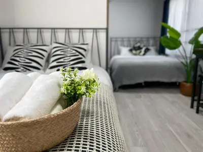 a bedroom with a bed and a basket of towels at Comma House Otsuka 3-2 in Tokyo