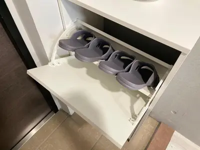 a row of purple toilets sitting on a shelf at Comma House Otsuka 3-2 in Tokyo