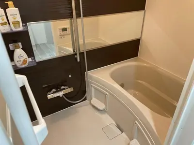 a small bathroom with a tub and a mirror at Comma House Otsuka 3-2 in Tokyo