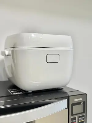 a white mixer sitting on top of a microwave at MIKASA guesthouse2 in Tokyo