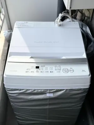 a white printer sitting on top of a refrigerator at MIKASA guesthouse2 in Tokyo