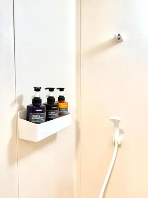 a bathroom door with four bottles of paint on it at MIKASA guesthouse2 in Tokyo