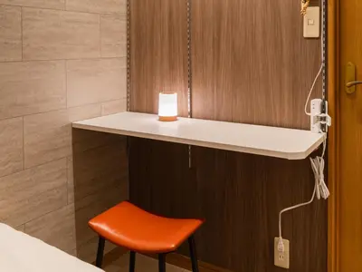 a room with a counter and a red chair at Ikebukuro-Shinjuku-5min Zoshigaya Sta-Easy train access to Shinjuku and Shibuya in Tokyo