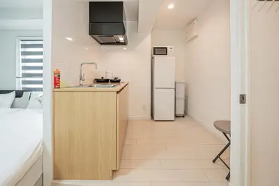 a kitchen with a sink and a refrigerator in a room at Japan House Edogawabashi Retaw Hills Aprtment in Tokyo