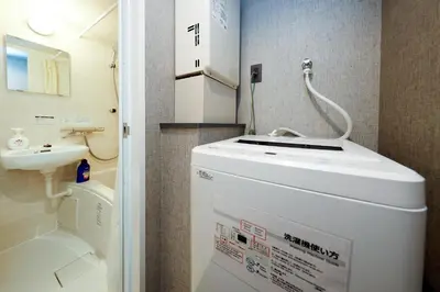 a small bathroom with a toilet and a sink at Flat K Plum Umegaoka by Tranova in Tokyo