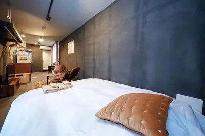 a bedroom with a large white bed with two towels on it at Flat K Plum Umegaoka by Tranova in Tokyo