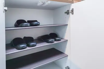 a walk in closet with black bowls on shelves at Flat K Plum Umegaoka by Tranova in Tokyo