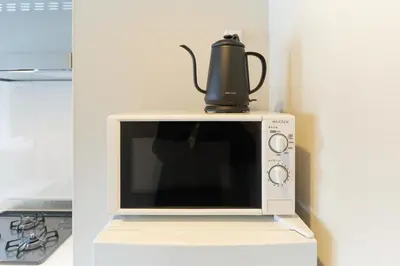 a microwave with a tea kettle on top of it at Cure Azumabashi by Tranova in Tokyo