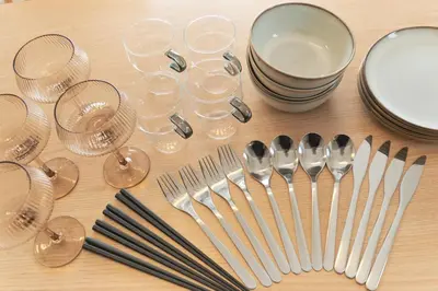 a table with forks and wine glasses and spoons at Cure Azumabashi by Tranova in Tokyo