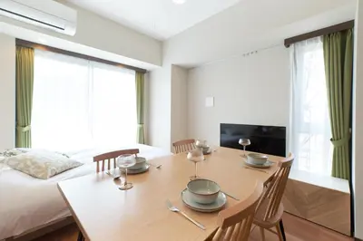 a dining room with a table and a bed at Cure Azumabashi by Tranova in Tokyo