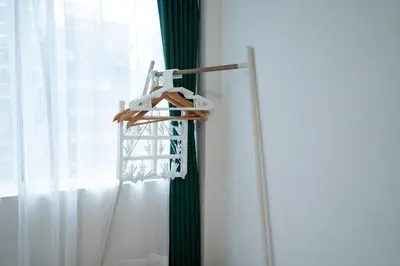 a towel rack next to a window with white curtains at Yamamoto building by Tranova in Tokyo