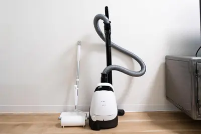 a vacuum cleaner sitting on the floor next to a wall at Yamamoto building by Tranova in Tokyo