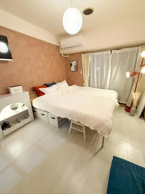 a bedroom with a large bed and a window at Omori 8min Stylish and comfortable room in Tokyo