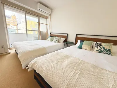 two beds in a room with a window at The Vera in Tokyo